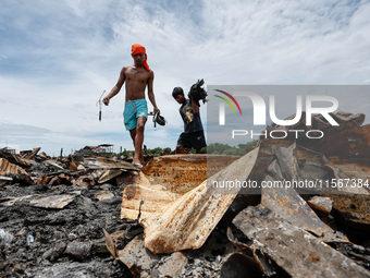 People look for salvageable items among the rubble of damaged houses following a huge fire that engulfs at least 800 houses in Bacoor, Cavit...