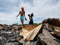 People look for salvageable items among the rubble of damaged houses following a huge fire that engulfs at least 800 houses in Bacoor, Cavit...