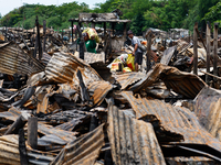 People look for salvageable items among the rubble of damaged houses following a huge fire that engulfs at least 800 houses in Bacoor, Cavit...