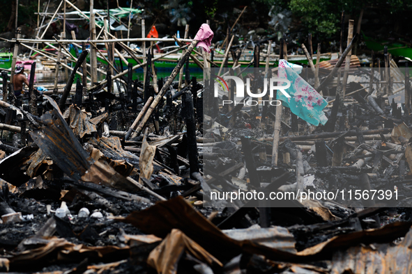 A towel hangs atop the rubble of damaged houses following a huge fire that engulfs at least 800 houses in Bacoor, Cavite, the Philippines, o...