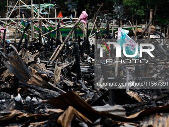 A towel hangs atop the rubble of damaged houses following a huge fire that engulfs at least 800 houses in Bacoor, Cavite, the Philippines, o...