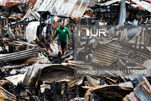 People look for salvageable items among the rubble of damaged houses following a huge fire that engulfs at least 800 houses in Bacoor, Cavit...