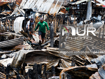 People look for salvageable items among the rubble of damaged houses following a huge fire that engulfs at least 800 houses in Bacoor, Cavit...