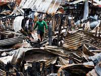 People look for salvageable items among the rubble of damaged houses following a huge fire that engulfs at least 800 houses in Bacoor, Cavit...