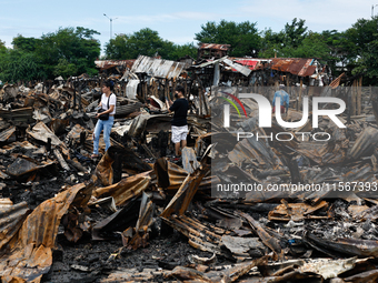 People look for salvageable items among the rubble of damaged houses following a huge fire that engulfs at least 800 houses in Bacoor, Cavit...