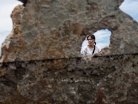 A woman searches for salvageable items among the rubble of damaged houses in Bacoor, Cavite, the Philippines, on September 12, 2024, followi...