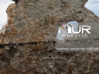 A woman searches for salvageable items among the rubble of damaged houses in Bacoor, Cavite, the Philippines, on September 12, 2024, followi...