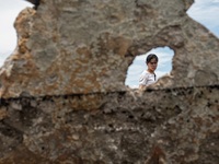 A woman searches for salvageable items among the rubble of damaged houses in Bacoor, Cavite, the Philippines, on September 12, 2024, followi...