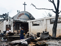 Children help remove the debris of damaged houses following a huge fire that engulfs at least 800 houses in Bacoor, Cavite, the Philippines,...