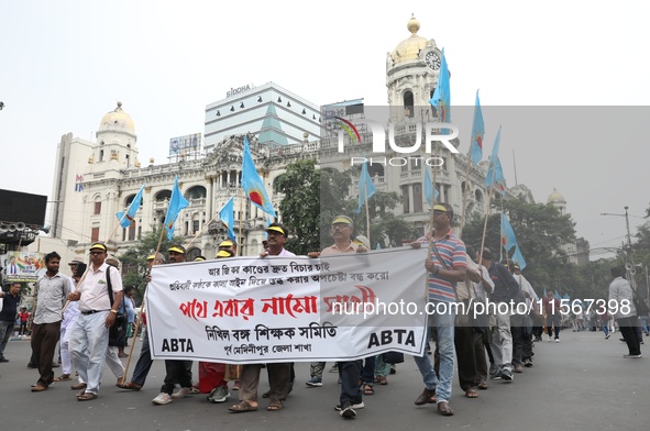 Members of the All Bengal Teachers Association, a teacher's movement in the Indian state of West Bengal, shout slogans during a protest rall...