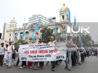 Members of the All Bengal Teachers Association, a teacher's movement in the Indian state of West Bengal, shout slogans during a protest rall...