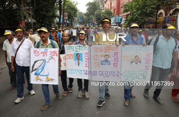 Members of the All Bengal Teachers Association, a teacher's movement in the Indian state of West Bengal, shout slogans during a protest rall...