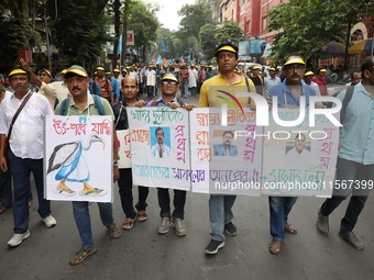 Members of the All Bengal Teachers Association, a teacher's movement in the Indian state of West Bengal, shout slogans during a protest rall...