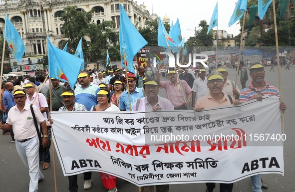 Members of the All Bengal Teachers Association, a teacher's movement in the Indian state of West Bengal, shout slogans during a protest rall...