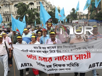 Members of the All Bengal Teachers Association, a teacher's movement in the Indian state of West Bengal, shout slogans during a protest rall...