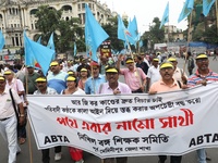 Members of the All Bengal Teachers Association, a teacher's movement in the Indian state of West Bengal, shout slogans during a protest rall...