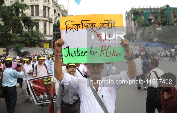 Members of the All Bengal Teachers Association, a teacher's movement in the Indian state of West Bengal, shout slogans during a protest rall...