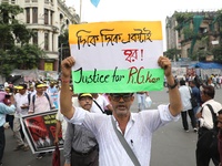 Members of the All Bengal Teachers Association, a teacher's movement in the Indian state of West Bengal, shout slogans during a protest rall...