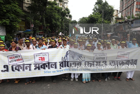 Members of the All Bengal Teachers Association, a teacher's movement in the Indian state of West Bengal, shout slogans during a protest rall...