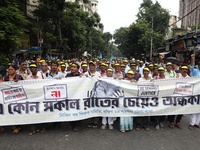 Members of the All Bengal Teachers Association, a teacher's movement in the Indian state of West Bengal, shout slogans during a protest rall...