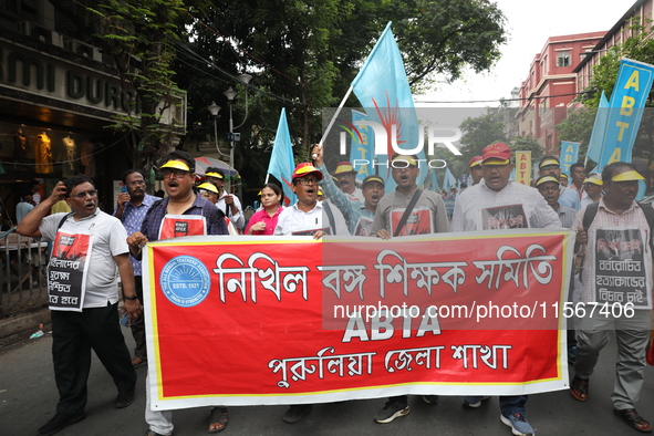 Members of the All Bengal Teachers Association, a teacher's movement in the Indian state of West Bengal, shout slogans during a protest rall...