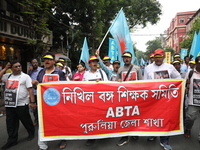 Members of the All Bengal Teachers Association, a teacher's movement in the Indian state of West Bengal, shout slogans during a protest rall...