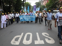 Members of the All Bengal Teachers Association, a teacher's movement in the Indian state of West Bengal, shout slogans during a protest rall...