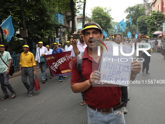 Members of the All Bengal Teachers Association, a teacher's movement in the Indian state of West Bengal, shout slogans during a protest rall...