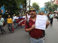 Members of the All Bengal Teachers Association, a teacher's movement in the Indian state of West Bengal, shout slogans during a protest rall...