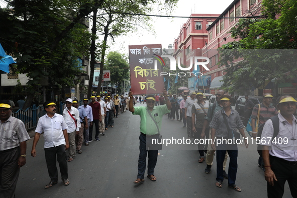 Members of the All Bengal Teachers Association, a teacher's movement in the Indian state of West Bengal, shout slogans during a protest rall...