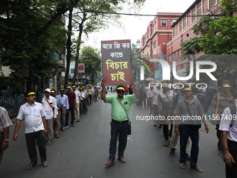 Members of the All Bengal Teachers Association, a teacher's movement in the Indian state of West Bengal, shout slogans during a protest rall...