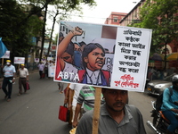 Members of the All Bengal Teachers Association, a teacher's movement in the Indian state of West Bengal, shout slogans during a protest rall...