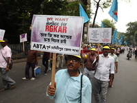 Members of the All Bengal Teachers Association, a teacher's movement in the Indian state of West Bengal, shout slogans during a protest rall...