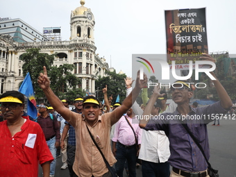 Members of the All Bengal Teachers Association, a teacher's movement in the Indian state of West Bengal, shout slogans during a protest rall...