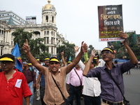 Members of the All Bengal Teachers Association, a teacher's movement in the Indian state of West Bengal, shout slogans during a protest rall...