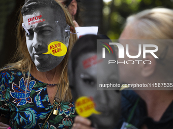 People wear masks of the mayor of Sofia and employees of the municipal shelters for stray dogs in front of the building of the Metropolitan...