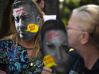 People wear masks of the mayor of Sofia and employees of the municipal shelters for stray dogs in front of the building of the Metropolitan...