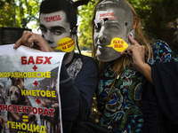 People wear masks of the mayor of Sofia and employees of the municipal shelters for stray dogs in front of the building of the Metropolitan...