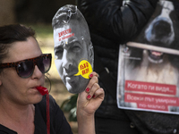 People wear masks of the mayor of Sofia and employees of the municipal shelters for stray dogs in front of the building of the Metropolitan...