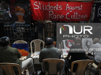 Artists paint canvases to protest an art camp at the roadside during a protest against the rape and murder of a PGT woman doctor at the gove...