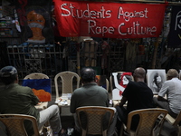 Artists paint canvases to protest an art camp at the roadside during a protest against the rape and murder of a PGT woman doctor at the gove...