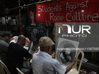 Artists paint canvases to protest an art camp at the roadside during a protest against the rape and murder of a PGT woman doctor at the gove...