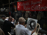 Artists paint canvases to protest an art camp at the roadside during a protest against the rape and murder of a PGT woman doctor at the gove...