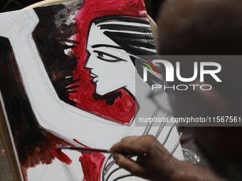 An artist paints a canvas to protest an art camp at the roadside during a protest against the rape and murder of a PGT woman doctor at the g...