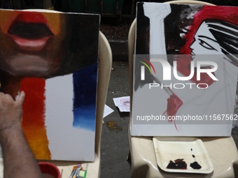 Artists paint on canvas to protest an art camp at Roar Side during a protest against the rape and murder of a PGT woman doctor at the govern...