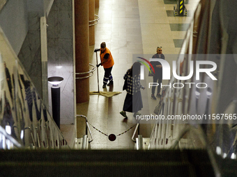 Passengers stay on the platform of the Demiivska metro station after the traffic launches following nine months of repairs in the tunnel bet...