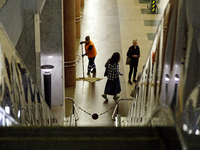 Passengers stay on the platform of the Demiivska metro station after the traffic launches following nine months of repairs in the tunnel bet...