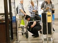 A Kyiv Metro worker measures the length of an electric kick scooter at the Demiivska metro station after the traffic launches following nine...