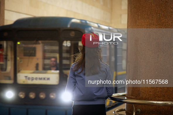 A Kyiv Metro worker stands on the platform of the Demiivska metro station after the traffic relaunches following nine months of repairs in t...