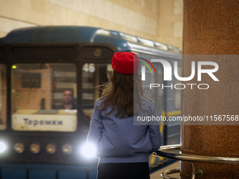 A Kyiv Metro worker stands on the platform of the Demiivska metro station after the traffic relaunches following nine months of repairs in t...